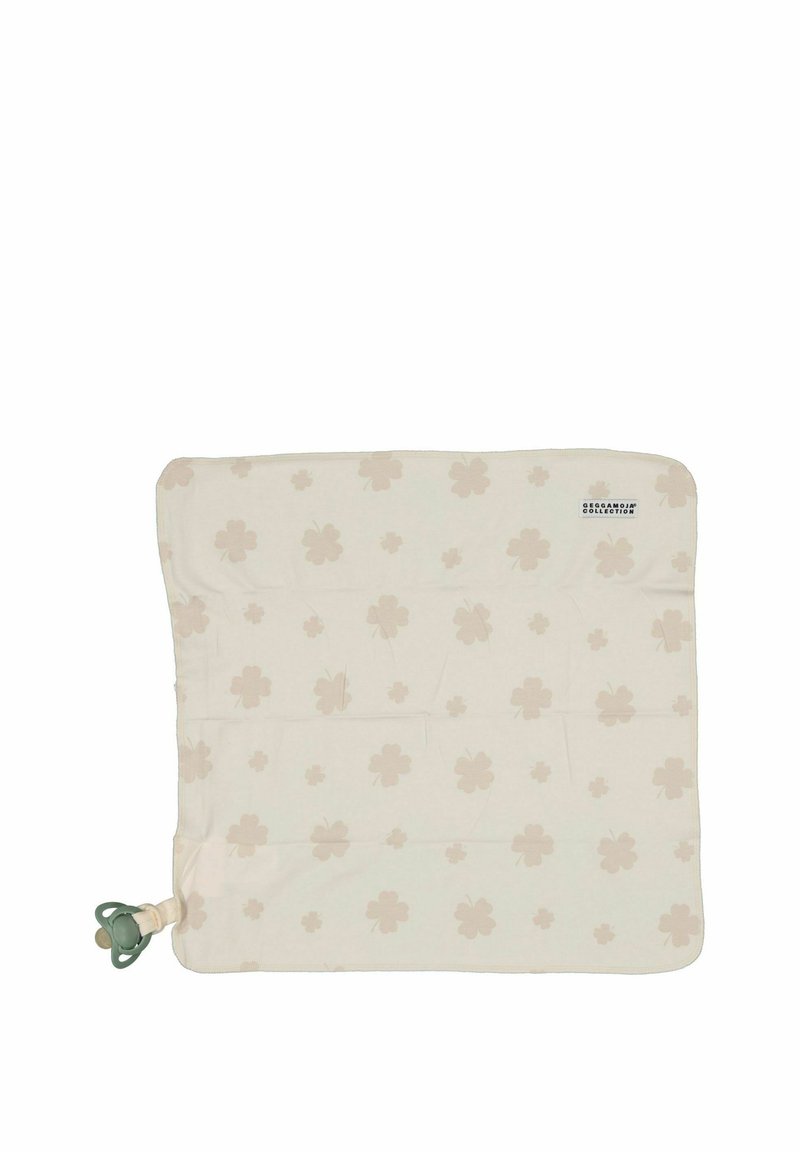 Bomullspläd i krämfärg med ljusbeiga klövermönster. Inkluderar en napphållare i ett hörn. Mjuk textur och rektangulär form.