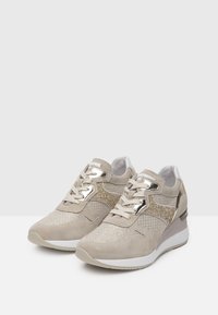 Beige suede sneakers with mesh and glitter accents. Features white laces, metallic hardware, and a textured sole for added grip.