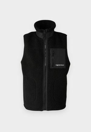 Black fleece vest with high collar, full front zipper, and a zippered chest pocket. Includes smooth fabric accents and side pockets.