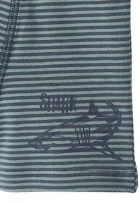 Navy and light blue striped fabric with stitched outline of shark and the word "SHARK" above the design.