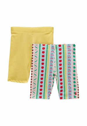 Dwie pary krótkich spodenek do kolan: jedne w jednolitym żółtym kolorze, drugie białe z pionowymi paskami ozdobionymi jabłkami, wiśniami, kwiatami i gruszkami.