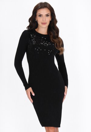 Abito lungo a maniche lunghe nero con effetto a coste, caratterizzato da un upper decorato con paillettes, una silhouette aderente e un orlo che arriva al ginocchio. Morbido al tatto.