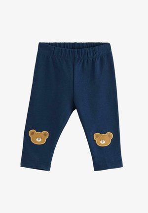 Tummansiniset legginsit, jotka on valmistettu pehmeästä kankaasta ja joissa on joustava vyötärö, sekä kaksi ruskeaa karhun applikaatiota jokaisessa polvessa.