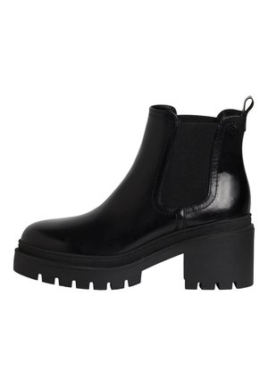 Bottine noire en cuir avec talon bloc épais, panneaux latéraux élastiques, languette à l'arrière et semelle à crampons robuste.