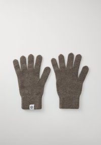 Gants en tricot marron avec un poignet à côtes et une petite étiquette. Le matériau est texturé, offrant un aspect doux et chaud.