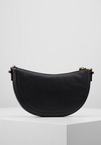 Bolso en forma de media luna de cuero negro con una superficie texturizada, cierre de cremallera dorado y un diseño minimalista.
