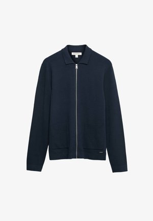 Námořnická modrá zapínací kardigán s dlouhými rukávy, límcem, dvěma předními našitými kapsami a kovovým tahem na zip.