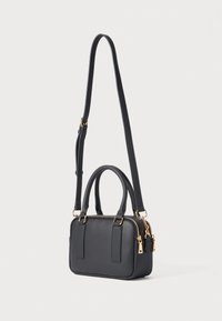 Black rectangular handbag with gold zippers, short handles, and a long adjustable shoulder strap on a light background.