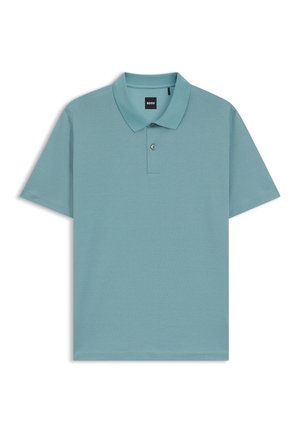 Light blue polo shirt featuring a textured pattern, short sleeves, and a classic collar with two buttons. Brand label visible on the collar.