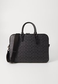 Black leather bag with a subtle patterned design, dual top handles, removable shoulder strap, and zip closure. Features a tag with branding.