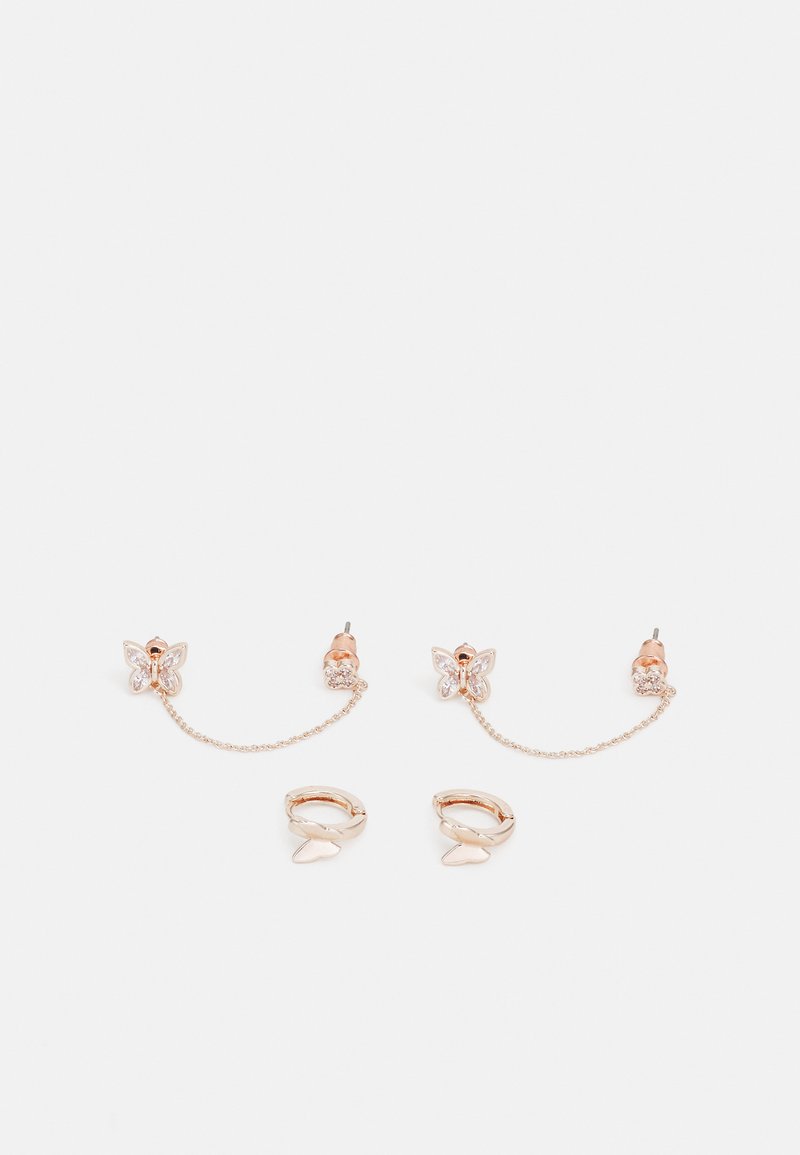 Rose-gold butterfly earrings with clear stone accents, featuring chain links and huggie-style clasps. Smooth texture and delicate design.