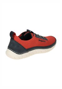 Red mesh sneaker with black and gray accents, textured upper, rubber sole, and contrasting stitching details. Lightweight design with reinforced heel.