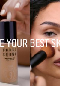Bobbi Brown Weightless Skin Foundation in a clear bottle with a black cap. Applied on skin using a makeup brush. Smooth texture, neutral color.