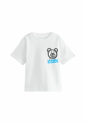 T-shirt bianco in cotone con maniche corte, caratterizzato da una grafica di un orso nero e il testo blu "GRANDI OBIETTIVI GRANDI SOGNI" sulla parte anteriore.