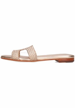 Woven leather slide sandal in metallic beige. Features two crossing straps, flat sole, and minimalistic design with wooden accent.