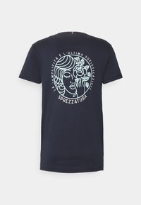 Navy blue cotton T-shirt featuring a graphic design of a woman's face with a flower, text encircling the design in light blue.