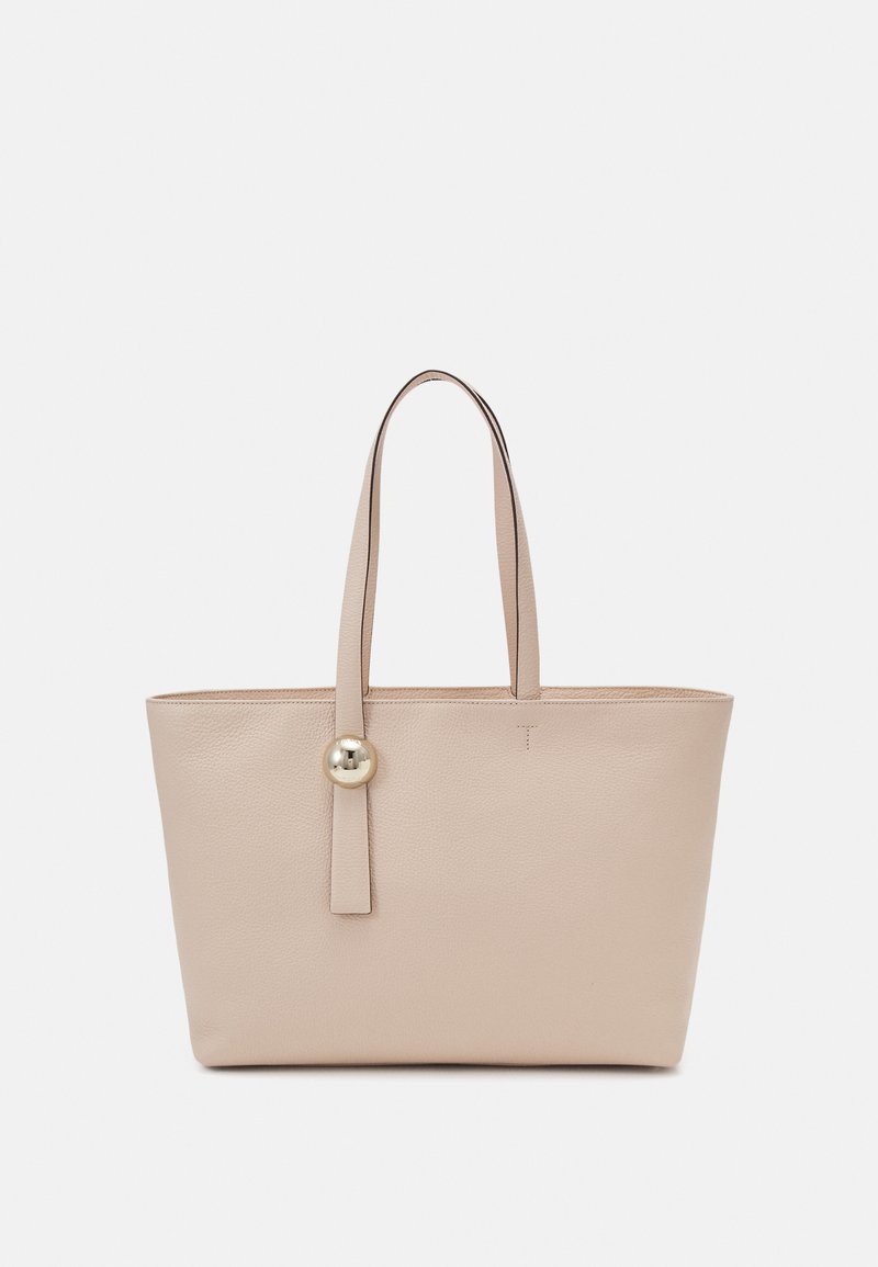 Beige Leder-Shopper mit zwei langen Griffen, einer strukturierten Oberfläche und einem auffälligen runden Hardware-Detail auf der Vorderseite.