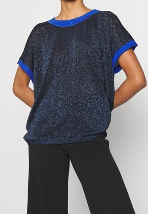 Haut noir à manches courtes avec des accents bleus, présentant un tissu texturé et scintillant ainsi qu'une coupe décontractée. Encolure ronde et manches à revers.