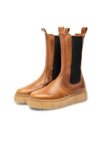 Brown leather ankle boots with elastic side panels, rounded toe, and thick, textured rubber sole for traction and comfort.