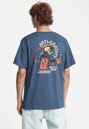 Navy blue cotton crew neck t-shirt featuring a colorful graphic on the back with text, depicting a monkey and beverage-related elements.
