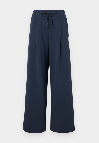 Navy wide-leg pants made from soft fabric, featuring an elastic waistband with a drawstring and side pleats for added structure.