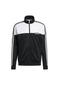 Svart och vit träningsjacka med hög krage, dragkedja och tre vita ränder längs axlarna och ärmarna. Inkluderar logotypdetalj.
