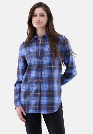 Camicia a quadri con colori blu e navy e accenti di un marrone chiaro. Design con bottoni, maniche lunghe e vestibilità rilassata. Tessuto morbido.