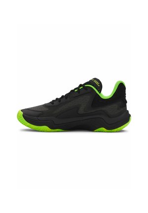 Black athletic shoes with green accents. Structured design with mesh and synthetic materials. Textured sole for grip. Laced closure.