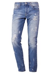 Ljusblå slitna jeans med slim fit. Har trasiga lappar, fem fickor och en dragkedja med knappstängning.