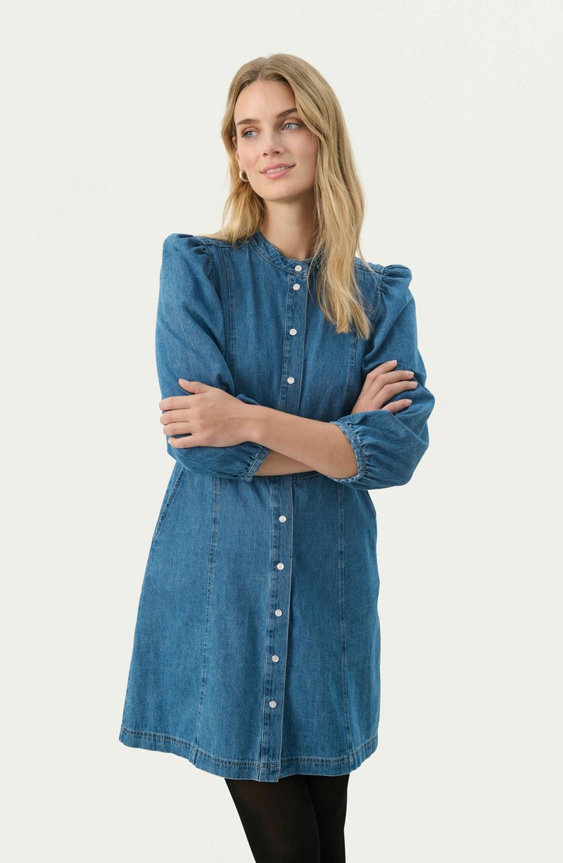 Denim dress with a button-down front, gathered sleeve detail, and a relaxed fit. Medium blue color and lightweight texture, knee length.