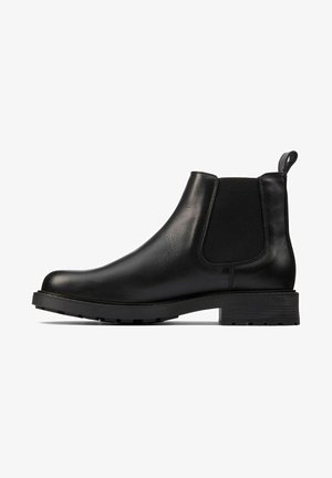 Bottes Chelsea en cuir noir avec panneaux élastiques sur les côtés, bout arrondi et languette de traction. Semelle en caoutchouc crantée pour une meilleure adhérence et durabilité.