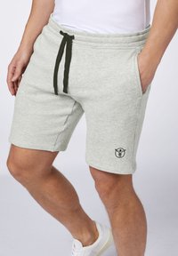 Gray cotton shorts with an elastic waistband and dark green drawstring. Features side pockets and a small black logo on the thigh.