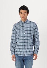 Blue plaid button-up shirt made of cotton, featuring a collar, long sleeves, and a slim fit. Notable white and navy check pattern.