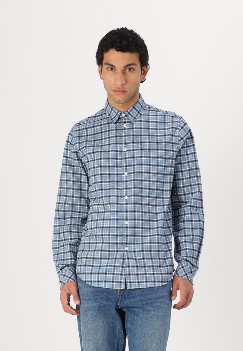 Blue plaid button-up shirt made of cotton, featuring a collar, long sleeves, and a slim fit. Notable white and navy check pattern.