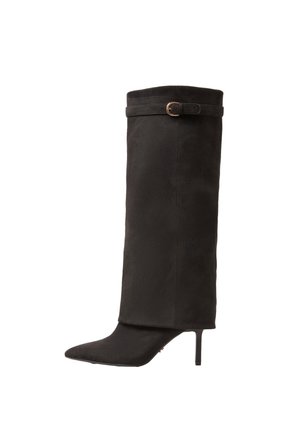 Black suede knee-high stiletto boot with pointed toe and decorative ankle strap with gold buckle on white background.
