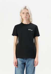 Black cotton t-shirt with short sleeves, featuring the word "REPLAY" in white print on the left chest. Casual, straight fit.