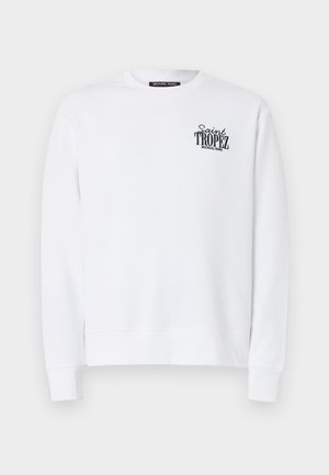 Balta krekla ar garo garām piedurknēm un apaļu apkakli, ar melnu uzrakstu “Saint Tropez Michael Kors” uz kreisā krūtīm.