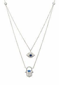 Silver layered necklaces with two pendants: an eye symbol and a hand symbol, both embellished with blue stones and intricate details.