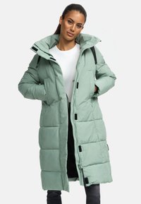 Long puffer coat in mint green with a zippered front, snap pockets, and black accents. Features a hood and quilted texture for insulation.