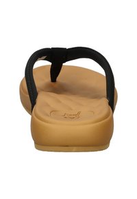 Black flip-flops with a textured tan sole, featuring a minimalist design and a wide strap for support. Brand logo embossed on footbed.