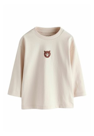 Crèmekleurig langermig peutershirt met een kleine, gecentreerde bruine berenkop op de borst en een geribde ronde hals.