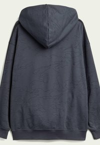 Huppari tummanharmaasta kankaasta, jossa on kohokuvioituja abstrakteja kuvioita. Sileä pinta ja ribbineulatuet hihat ja helma.