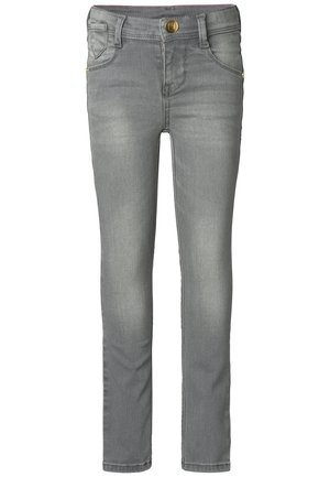 Graue Denim-Jeans mit figurbetontem Schnitt, Fünf-Taschen-Stil, Messingbeschlägen und leichter Waschung für einen getragenen Look.