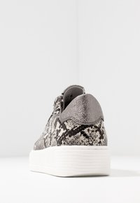 Sneaker with a textured black and white snakeskin pattern, grey leather accents, and a white rubber sole. Features a padded collar.