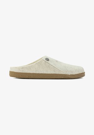 Wool slip-on slippers in light cream with a textured surface and a brown rubber sole; features a decorative metal logo accent.