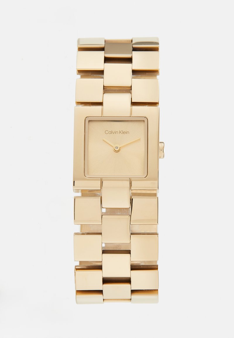 Gold-toned rectangular wristwatch with a square face, minimalist design, linked metal bracelet, and subtle logo on the dial.