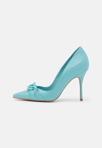 Light blue leather high-heeled pump featuring a pointed toe, a twist bow detail on the front, and a slender stiletto heel.