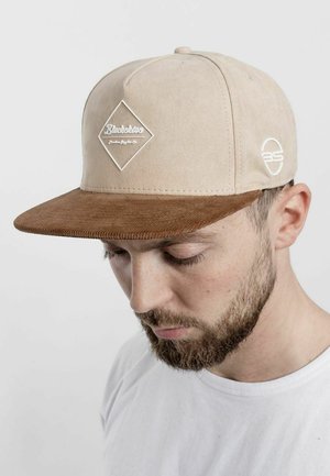 Beige suede cap with a brown corduroy peak, featuring a white diamond logo and an embroidered circular logo on the side.