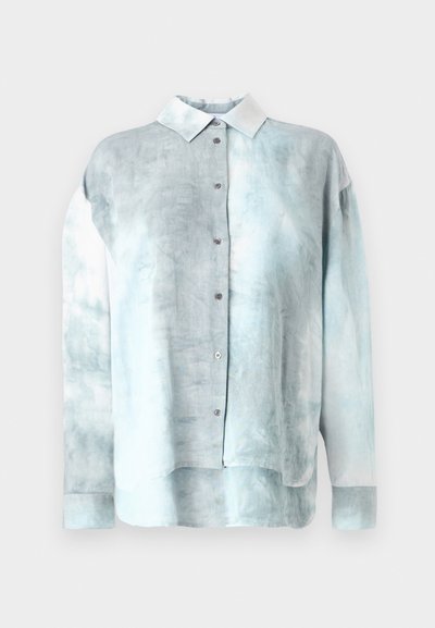 Light blue tie-dye button-up shirt with a white collar and long sleeves, made of soft fabric with a relaxed fit and rounded hem.