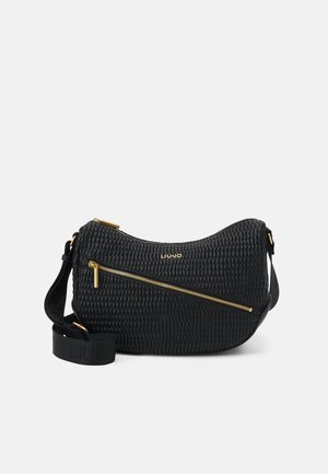 Musta teksturoitu olkalaukku, jossa on kullanväriset vetoketjut ja brändätty logo. Säädettävä hihna monipuolisiin kantotapoihin.